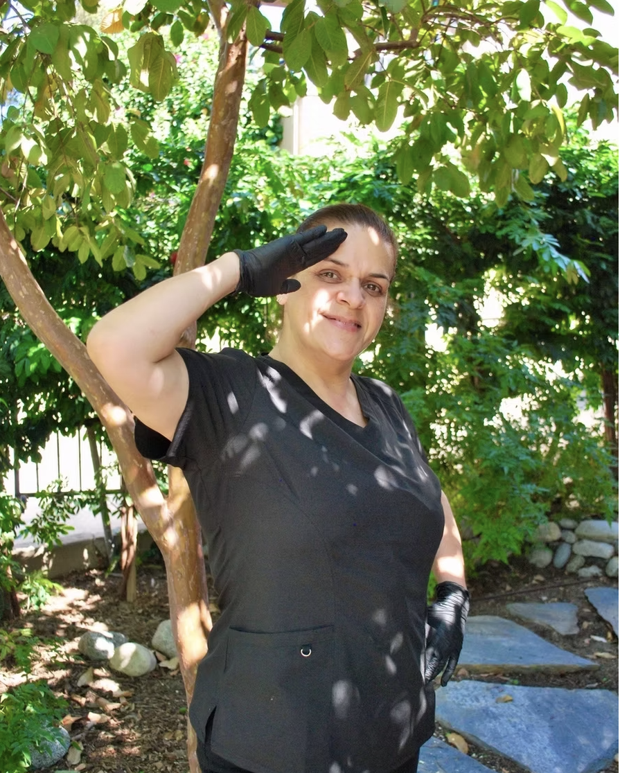 Kleen cleaner saluting under a tree