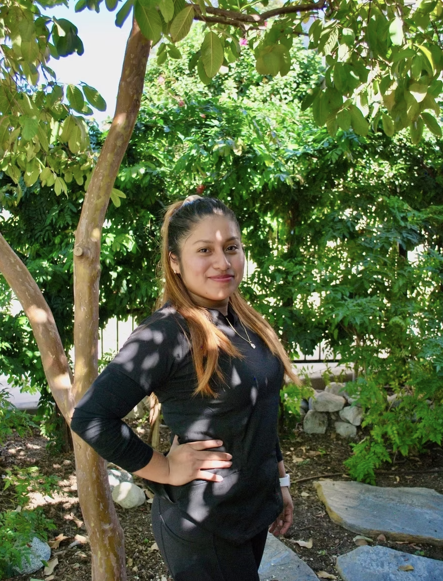 Kleen team member smiling in a shaded garden