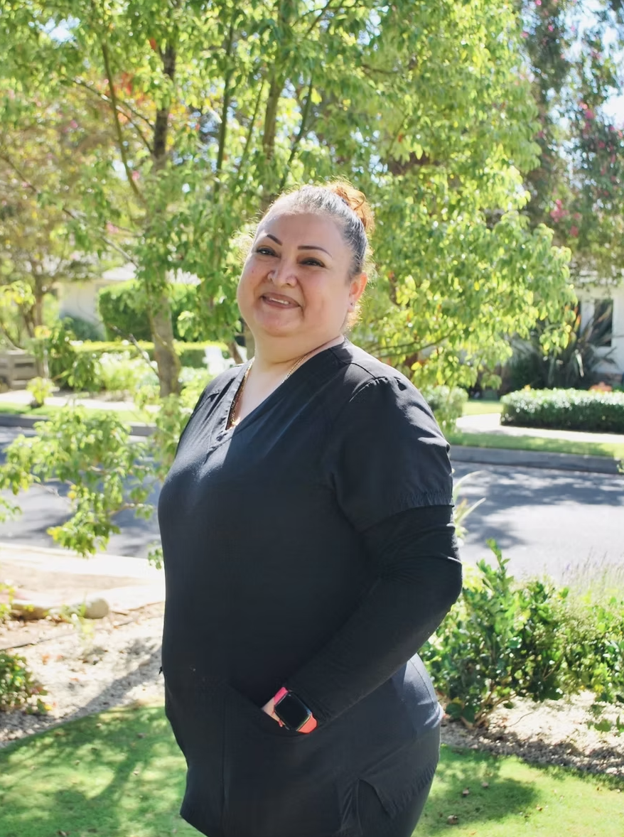Smiling Kleen team member outside a client's home